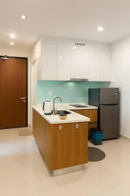 a kitchen with a sink and a refrigerator at 2 Connecting Room, Kozi Square, 9A & 9B in Gua Sai