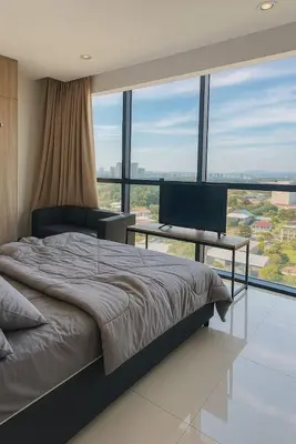 a bedroom with a bed and a desk with a computer at 2 Connecting Room, Kozi Square, 9A & 9B in Gua Sai