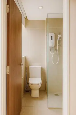 a bathroom with a toilet and a glass shower at 2 Connecting Room, Kozi Square, 9A & 9B in Gua Sai