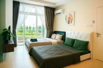 two beds in a room with a window at 2 Connecting Room, Riverine Diamond, 5A & 5B in Gua Sai