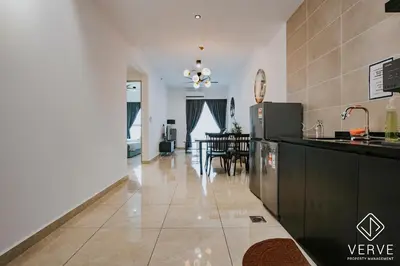 a kitchen with a counter and a dining room at Ipoh Town ICC Premium Suites by Verve 2B2B in Ipoh