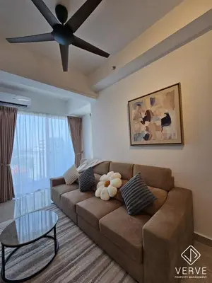 a living room with a brown couch and a ceiling fan at Ipoh Town ICC Premium Suites by Verve 2B2B in Ipoh