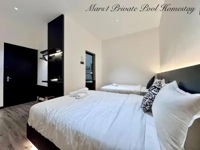 a bedroom with a large bed with white sheets and pillows at Mars1 Private Pool Homestay in Ipoh