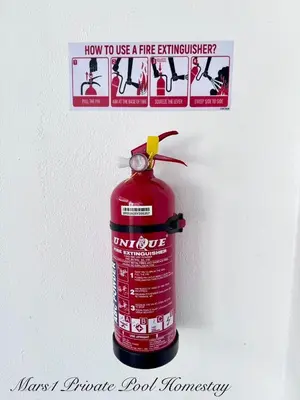 a bottle of fire extinguisher on the side of a refrigerator at Mars1 Private Pool Homestay in Ipoh
