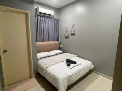 a small bedroom with a bed with a black object on it at Pangkor Villa 16 Homestay 4Rooms 3Bathroom Free WIFI & Karaoke in Pangkor