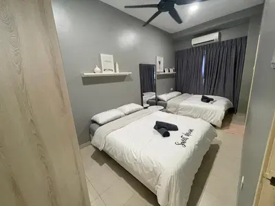 a bedroom with two beds and a ceiling fan at Pangkor Villa 16 Homestay 4Rooms 3Bathroom Free WIFI & Karaoke in Pangkor