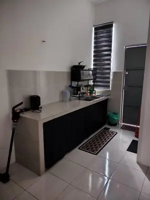a kitchen with a sink and a counter top at Nazana Homestay in Batu Gajah