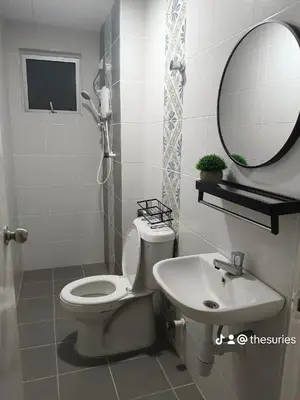 a bathroom with a toilet and a sink and a mirror at Apartment In Ipoh, City View in Ipoh