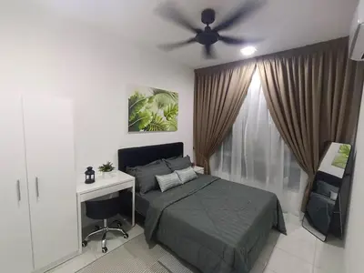 a bedroom with a bed and a desk and a ceiling fan at Apartment In Ipoh, City View in Ipoh