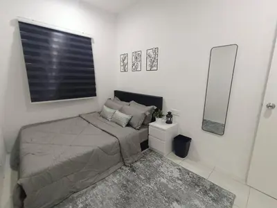 a small bedroom with a bed and a mirror at Apartment In Ipoh, City View in Ipoh