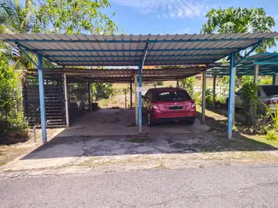 a garage with a car parked under a metal roof at Sacha Semarak in Baling