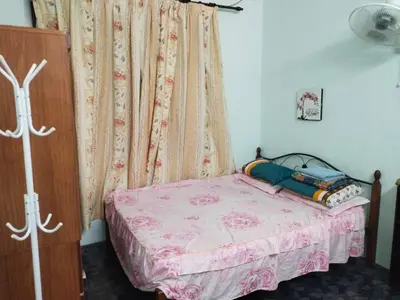 a small bedroom with a bed and a curtain at Sacha Semarak in Baling