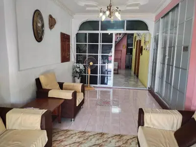 a living room with a couch and a table at Sacha Semarak in Baling