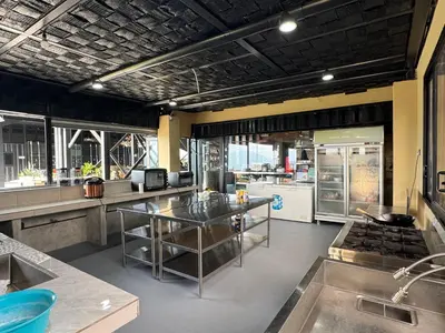 a large kitchen with a counter top and a stove at Jef Hill Villa Ipoh in Kampong Batu Lapan