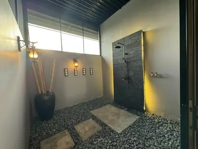 a bathroom with a shower with a vase and a window at Jef Hill Villa Ipoh in Kampong Batu Lapan