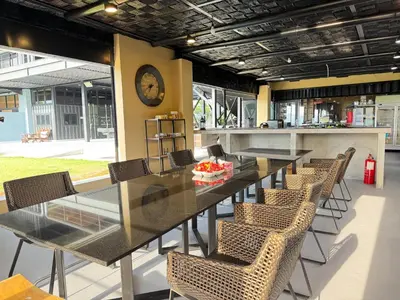 a dining room with a long table and chairs at Jef Hill Villa Ipoh in Kampong Batu Lapan