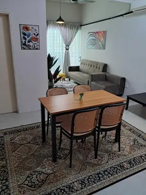 a living room with a wooden table and chairs at Serra Homestay at Apartment Bukit Permata, Lumut in Lumut