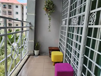 a balcony with purple and yellow stools on a building at Serra Homestay at Apartment Bukit Permata, Lumut in Lumut
