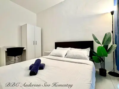 a bedroom with a bed with a blue towel on it at BBC Anderson Soo Homestay in Ipoh