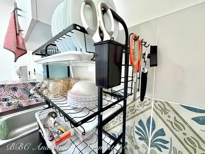 a rack with scissors and plates on a kitchen counter at BBC Anderson Soo Homestay in Ipoh