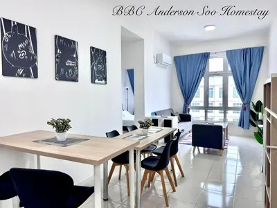 a dining room with a wooden table and chairs at BBC Anderson Soo Homestay in Ipoh