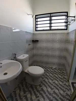 a bathroom with a toilet and a sink at ShaFA Homestay in Seri Iskandar