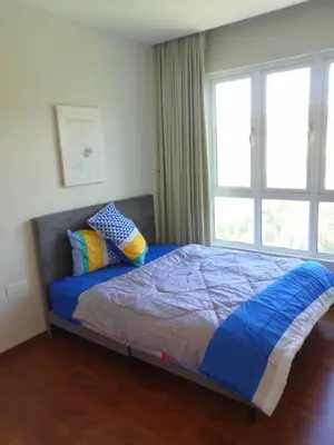 a bedroom with a bed with blue sheets and two pillows at The Haven 3 rooms residence Ipoh in Ipoh