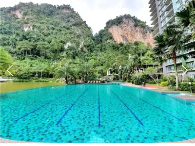 an empty swimming pool with mountains in the background at The Haven 3 rooms residence Ipoh in Ipoh