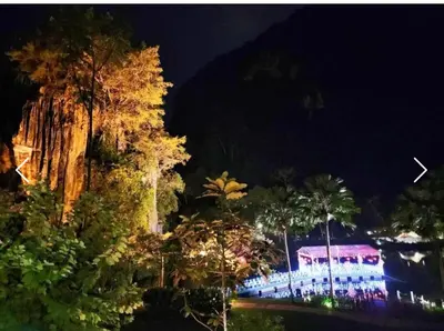 a night view of a resort with palm trees and a building at The Haven 3 rooms residence Ipoh in Ipoh
