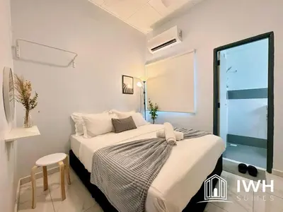 a white bedroom with a bed and a window at Waterfall Guesthouse 4R3B 12pax 3Car KTV BBQ Pool table in Ipoh