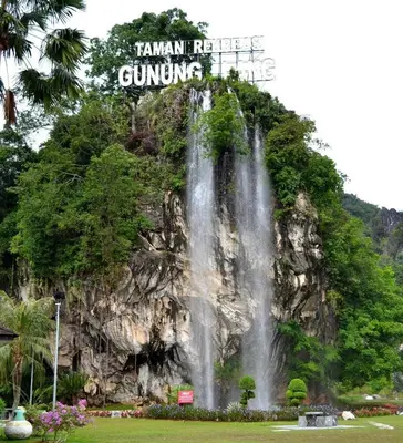a waterfall on the side of a mountain at Waterfall Guesthouse 4R3B 12pax 3Car KTV BBQ Pool table in Ipoh