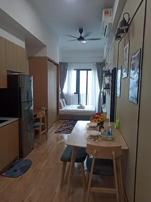 a kitchen and living room with a table and a room with a couch at Kuala Lumpur in Gua Sai