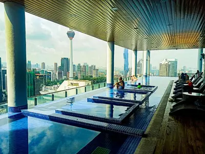a swimming pool on top of a building with a city skyline at Kuala Lumpur in Gua Sai