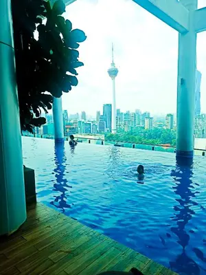 a swimming pool with a city skyline in the background at Kuala Lumpur in Gua Sai