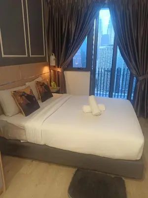a bedroom with a large bed with a large window at Kuala Lumpur in Gua Sai