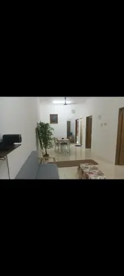 a living room with a table and a dining room at Homestay one3nine in Kampong Batu Tiga