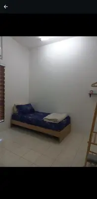 a bed sitting in a corner of a room at Homestay one3nine in Kampong Batu Tiga