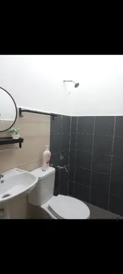 a bathroom with a white toilet and a sink at Homestay one3nine in Kampong Batu Tiga