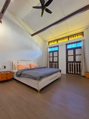 a bedroom with a bed and a ceiling fan at Popular! 4 pax Georgetown Heritage Pre-war House 2 Bedroom in George Town