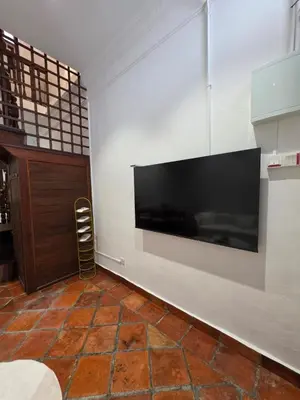 a living room with a large flat screen tv on a wall at Popular! 4 pax Georgetown Heritage Pre-war House 2 Bedroom in George Town