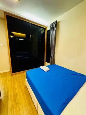 a bedroom with a blue bed with a large window at Batu Ferringhi PoolBBQ 5minBeach Night Market20pax in Batu Ferringhi
