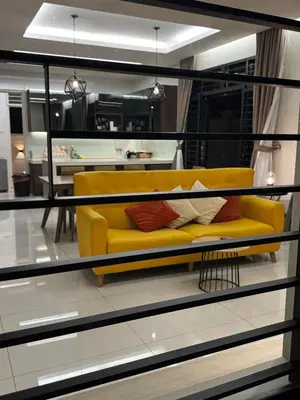 a yellow couch sitting inside of a living room at Batu Ferringhi PoolBBQ 5minBeach Night Market20pax in Batu Ferringhi