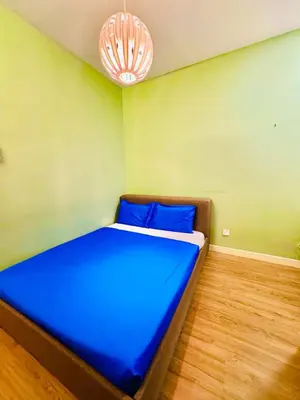 a bedroom with a large bed with blue sheets at Batu Ferringhi PoolBBQ 5minBeach Night Market20pax in Batu Ferringhi