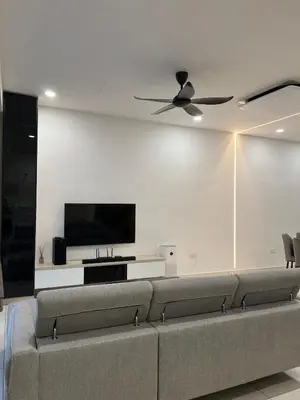 a living room with a couch and a flat screen tv at Cozy Home Simpang Ampat in Simpang Ampat