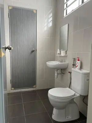 a bathroom with a toilet and a sink at Cozy Home Simpang Ampat in Simpang Ampat