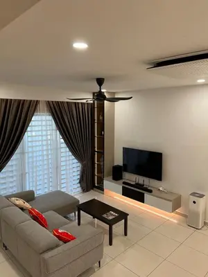 a living room with a couch and a flat screen tv at Cozy Home Simpang Ampat in Simpang Ampat