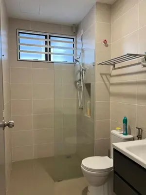 a bathroom with a shower and a toilet and a sink at Cozy Home Simpang Ampat in Simpang Ampat