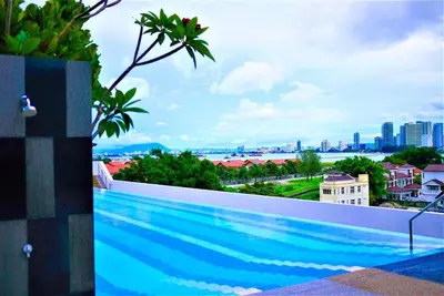 a swimming pool with a view of the city at Black Martini Premium Suite in Tanjong Tokong