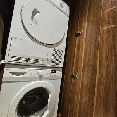 a washing machine with a mirror on top of it at Black Martini Premium Suite in Tanjong Tokong