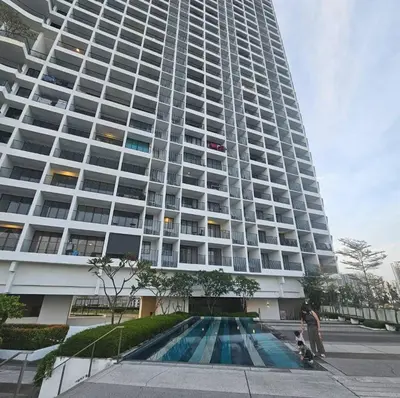 a large building with a swimming pool in front of it at Black Martini Premium Suite in Tanjong Tokong
